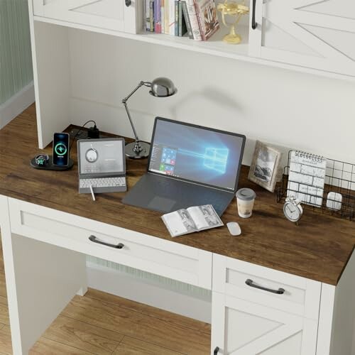 Home office desk with a laptop, tablet, and phone.