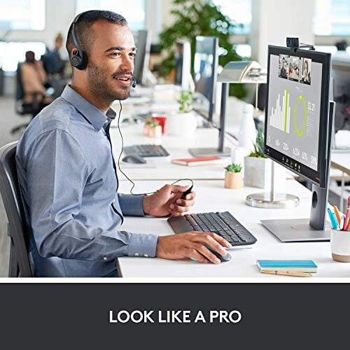 Office worker using a computer with headset in modern workspace