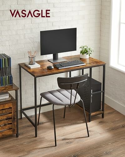 Industrial-style computer desk with monitor, keyboard, and chair.